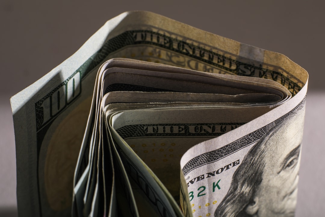 Rolled us hundred dollar bills with benjamin franklin visible.